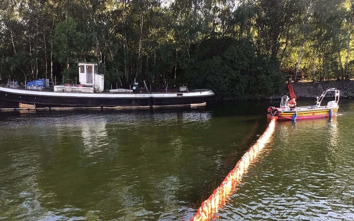 Ölsperre zwischen einem Schiff und dem Feuerwehrboot
