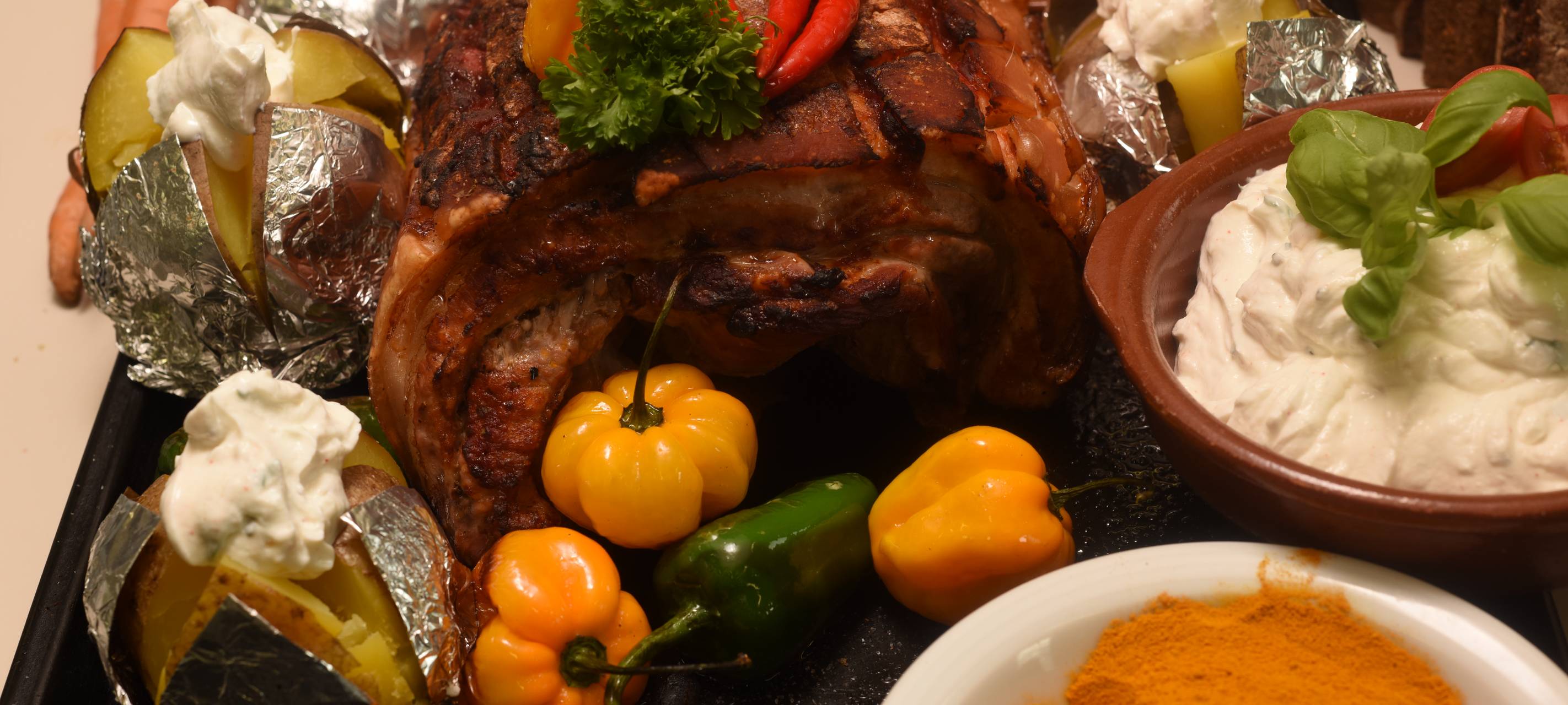 Mit Curry marinierter Schweinebauch mit Ofenkartoffeln und Schmand