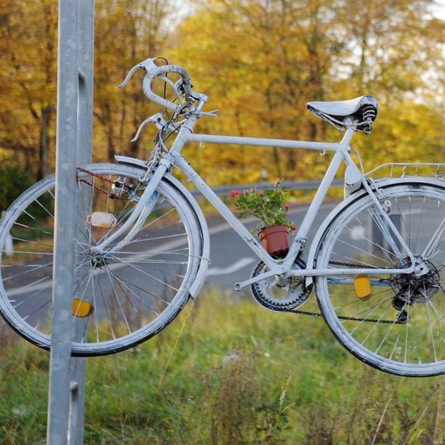 Ein Ghost Bike hängt an einer Laterne